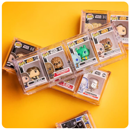 Yellow background with Bitty POP! accessories like acrylic cases