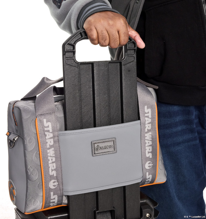 Close up image of the Loungefly COLLECTIV Star Wars Rebel Alliance The EXECUTIV Laptop Bag attached to the handle of a rolling suitcase
